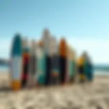 A selection of various foil surfboards displayed on a beach