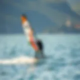 A Beginner's Glide: Embracing the Freedom of Wing Foiling Beginner wing foiler gliding on water with a scenic backdrop