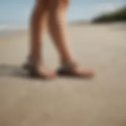 An elegant pair of Billabong sandals on a sandy beach