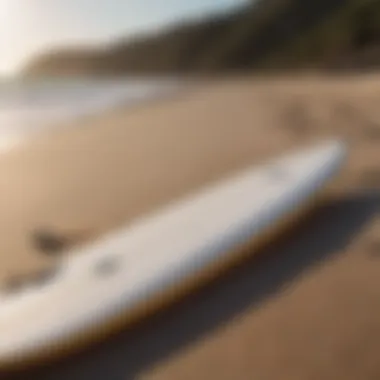 A well-maintained foam surfboard resting on the beach.