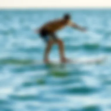 Practicing Balance on Water An individual practicing balance on a surfboard in shallow water