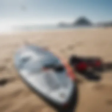 Essential kite surfing gear laid out on the sandy beach, showcasing boards and kites