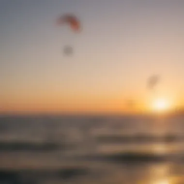 A breathtaking sunset over the sea with kitesurfers enjoying their late-afternoon session.