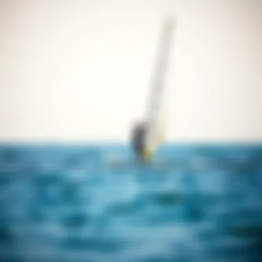 Paddle boarder enjoying the wind with a sail on open water