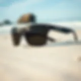 Close-up view of stylish surf sunglasses on a sandy beach