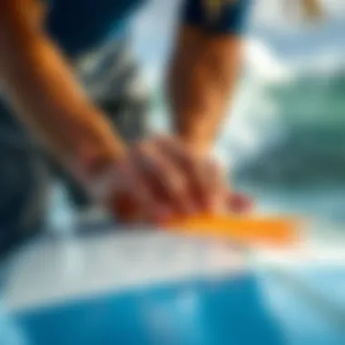 Detailed view of a surfer applying grip tape on a surfboard