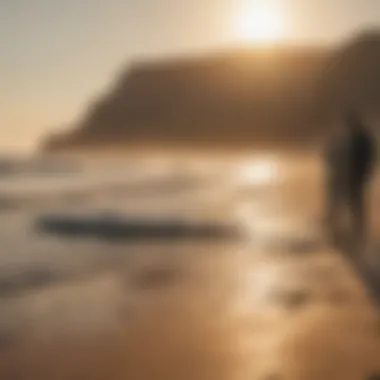 Surfers preparing their equipment on the beach at sunrise