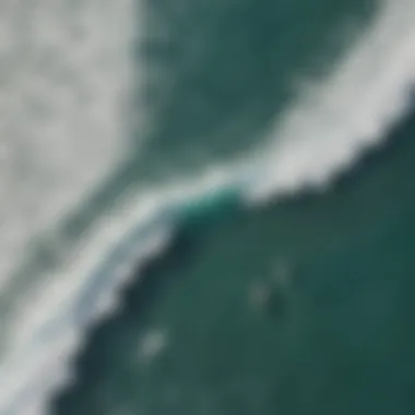 An aerial view of surfers in the ocean, showcasing their interaction with waves