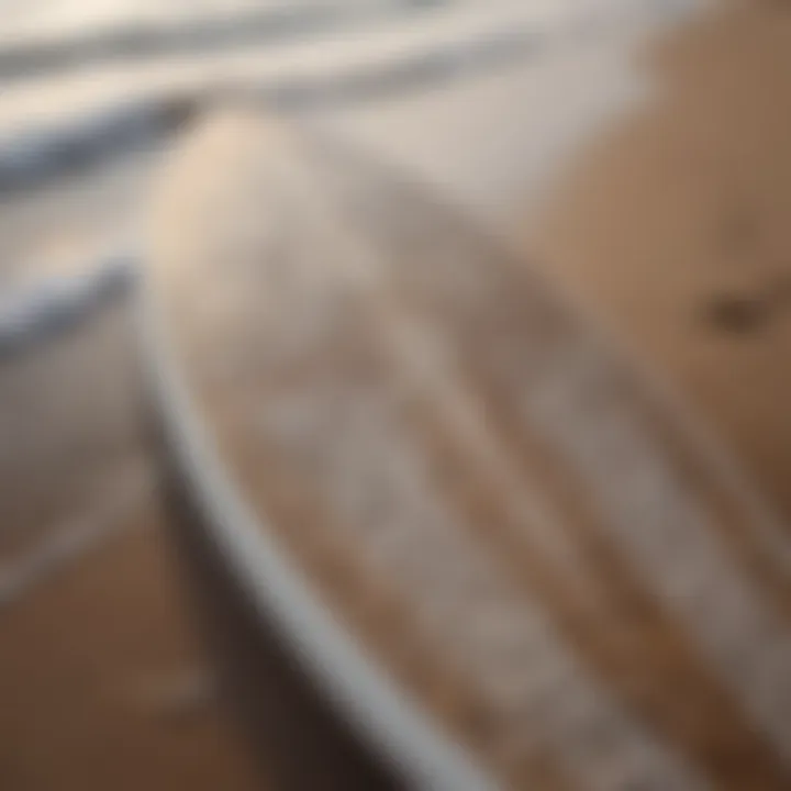 Close-up of a surfboard with intricate designs on the beach