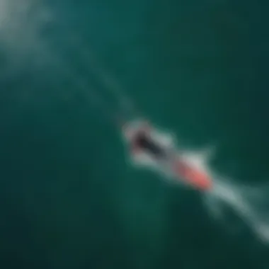 A stunning aerial view of a foil kiteboarder gliding over crystal clear water