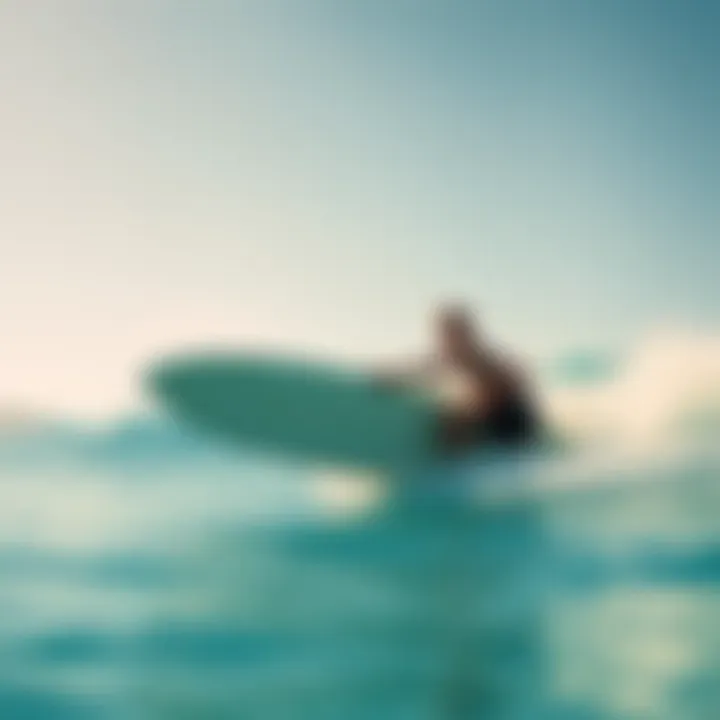 A surfer navigating through vibrant turquoise waters under a clear sky
