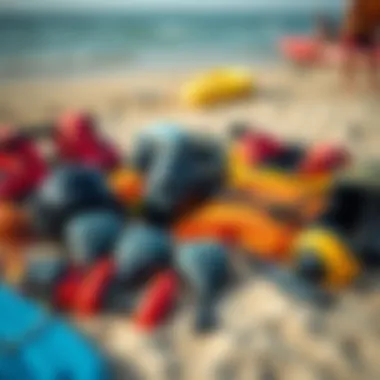 An assortment of watersport equipment laid out on the beach, highlighting safety gear and accessories