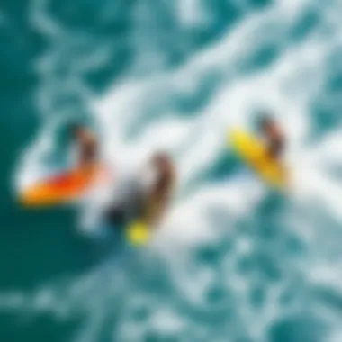 Surfers Embracing the Thrill of Motorized Surfing An aerial view of surfers enjoying motorized surfboards in a vibrant sea