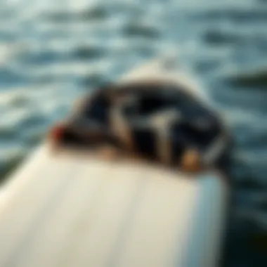 Billabong changing towel draped over surfboard by the water