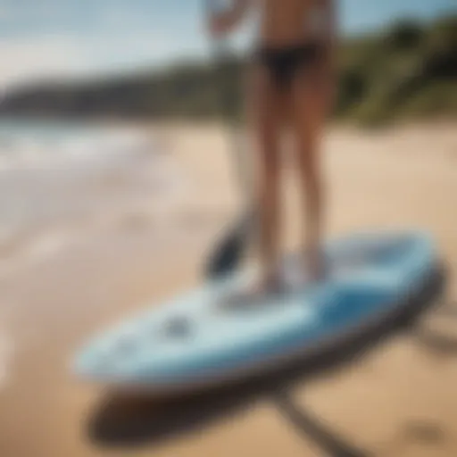 A folding stand-up paddle board on a sunny beach