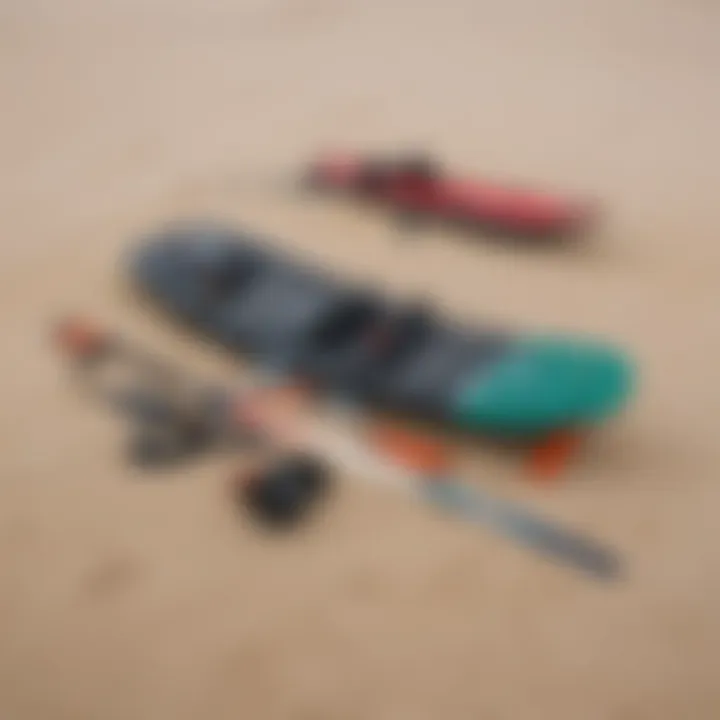 A close-up of essential kiteboarding equipment laid out on the sand