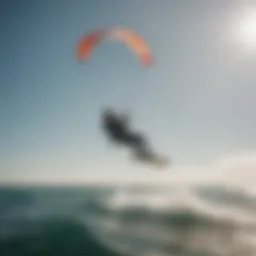 A kitesurfer gliding gracefully across calm waters under a clear sky