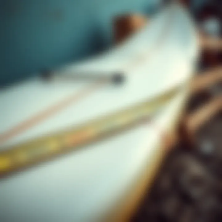 Surfboard Dimensions and Specifications Close-up view of surfboard dimensions with measuring tape, highlighting length and width specifications.