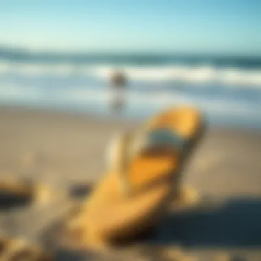 Sanuk Sandy Flip Flops on the Shore Stylish Sanuk Sandy flip flops on a sandy beach