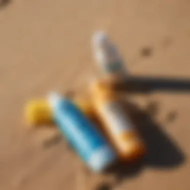 Close-up of sunscreen bottles on a sandy beach