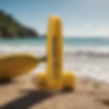 Close-up of Sun Bum Banana Lip Balm with scenic beach background