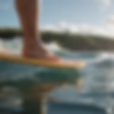 Close-up of a surfer’s feet on a surfboard in a yoga pose