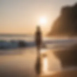 A surfer practicing yoga on the beach at sunrise