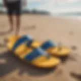 A pair of stylish surf slippers on a sandy beach