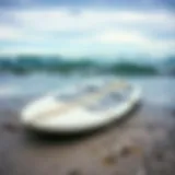 Weathered Surfboard on the Shore A weathered surfboard washed ashore, showcasing the passage of time and nature's elements