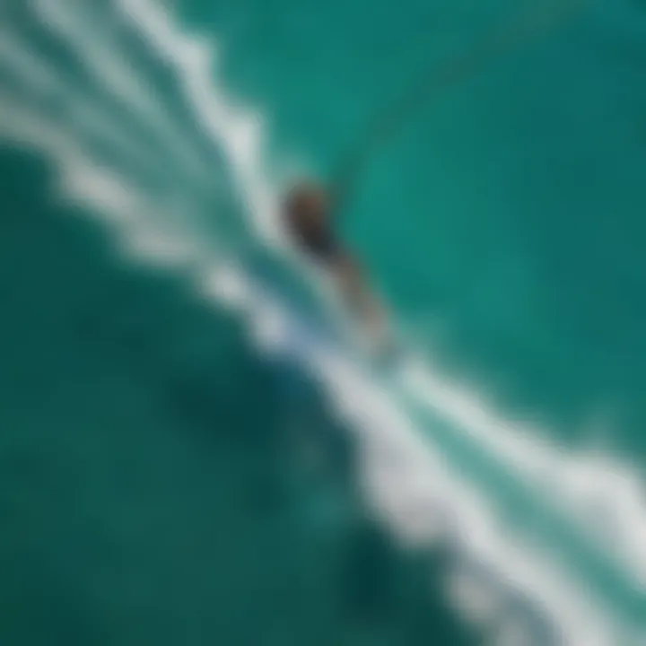 An aerial view of a kiteboarder soaring above turquoise waters, showcasing kite clearance during a dynamic maneuver.