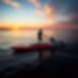 A sleek motorized paddleboard gliding over calm waters at sunset