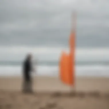 A user setting up a portable windsock in a beach environment