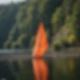 A vibrant portable windsock fluttering in the breeze at a lakeside